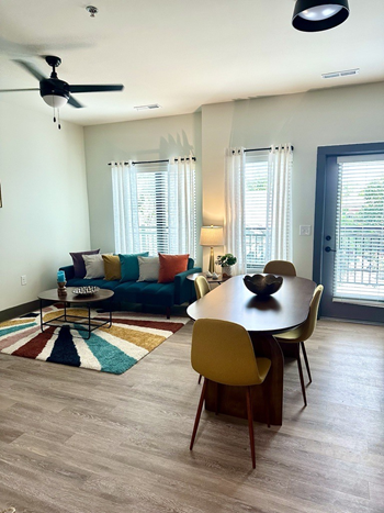 a living room with a dining room table and a couch